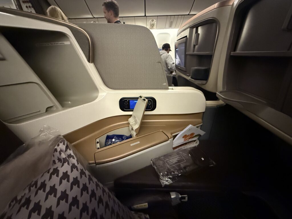 Two business class seats with a closed privacy divider