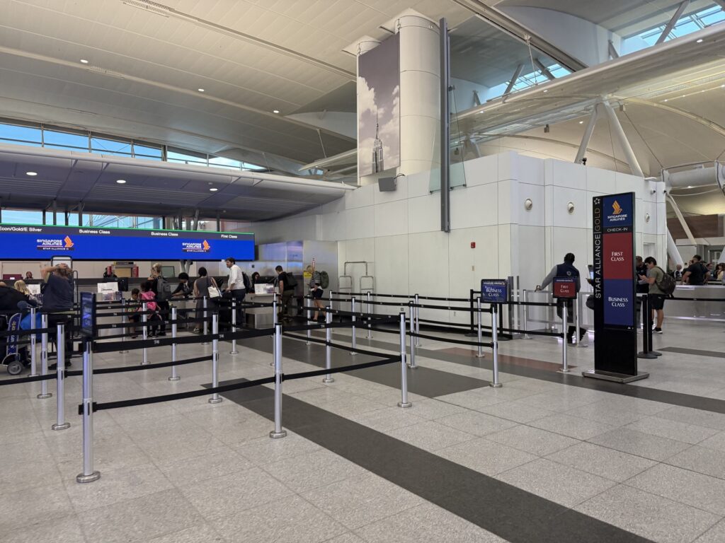 Photo of an empty airport queue with a sign for Singapore Airlines Business Class.